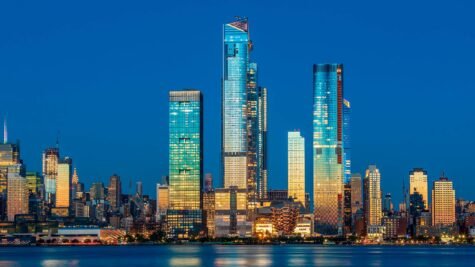 View to Manhattan skyline from Weehawken Waterfront in Hudson River at sunset.